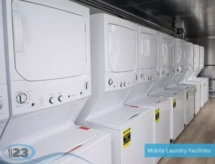 Commercial washers and dryers installed inside a Deluxe mobile laundry trailer