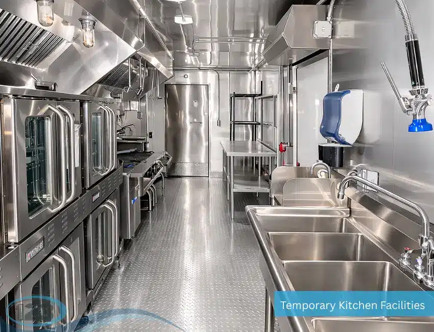 Stainless steel commercial cooking and preparation line inside a mobile kitchen trailer