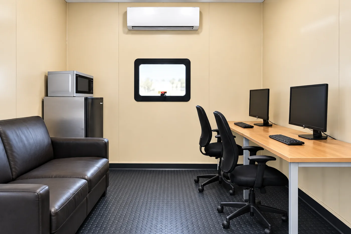 Computer workstations and seating inside a temporary office trailer
